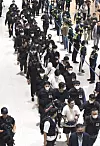 Korean nationals who were arrested by Cambodian authorities on suspicion of taking part in criminal syndicates in the Southeast Asian country are escorted by Korean officials at Incheon International Airport upon their repatriation on Oct. 18. [JOINT PRESS CORPS]