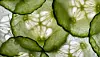 Close-up of overlapping cucumber slices with seeds visible.