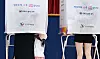 People stand at voting booths inside a school gymnasium polling station in Daejeon.