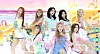 Eight members of Hearts2Hearts pose and perform on a colorful stage with pastel props and fruit-themed decorations.