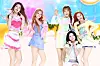 Five members of Hearts2Hearts pose and perform on a brightly lit stage with pastel props and a colorful backdrop.